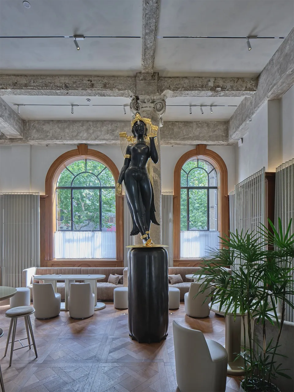 A modern interior space featuring a metallic statue