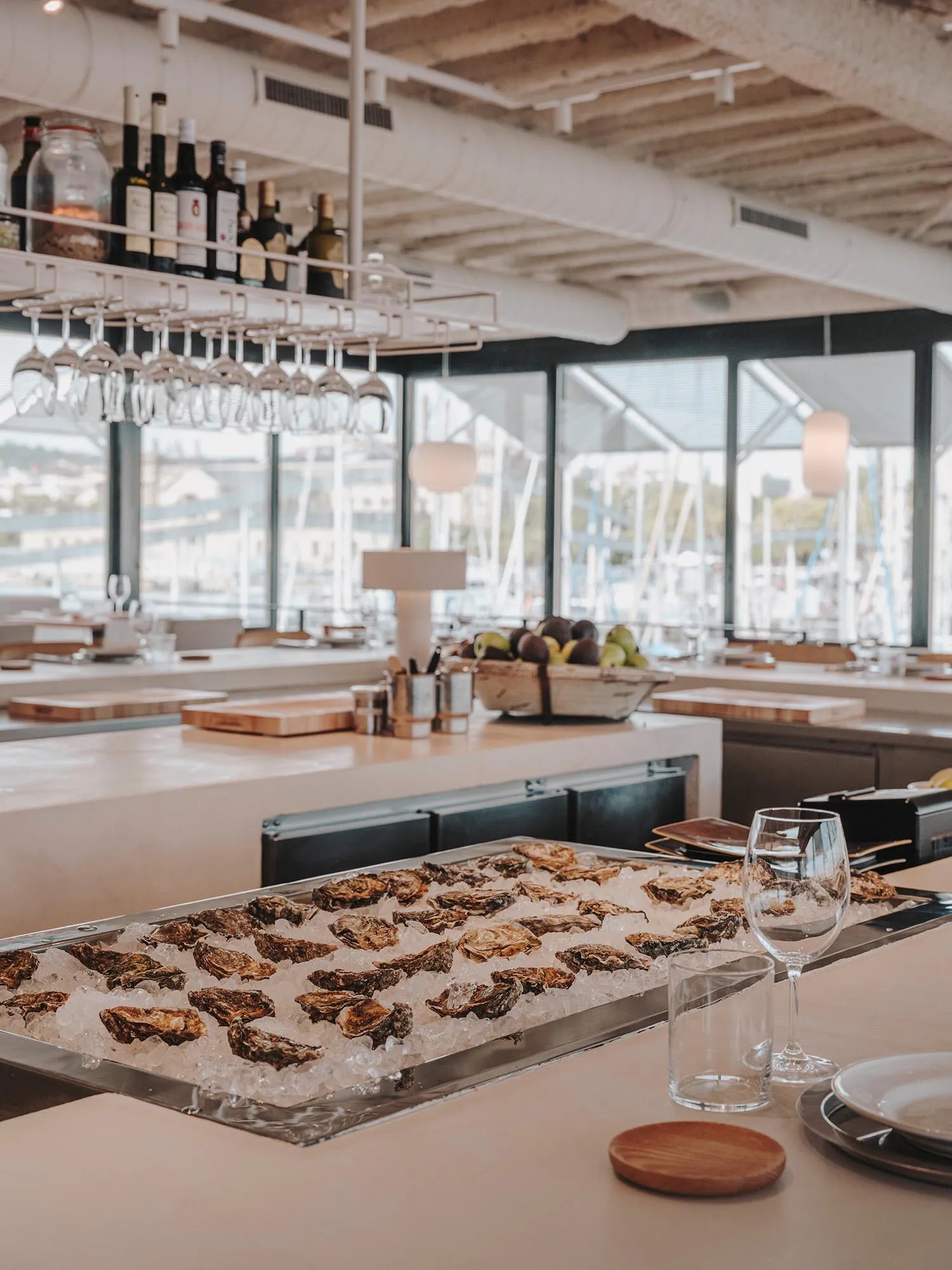 Oyster bar with granite flooring and a variety of raw oysters on ice.