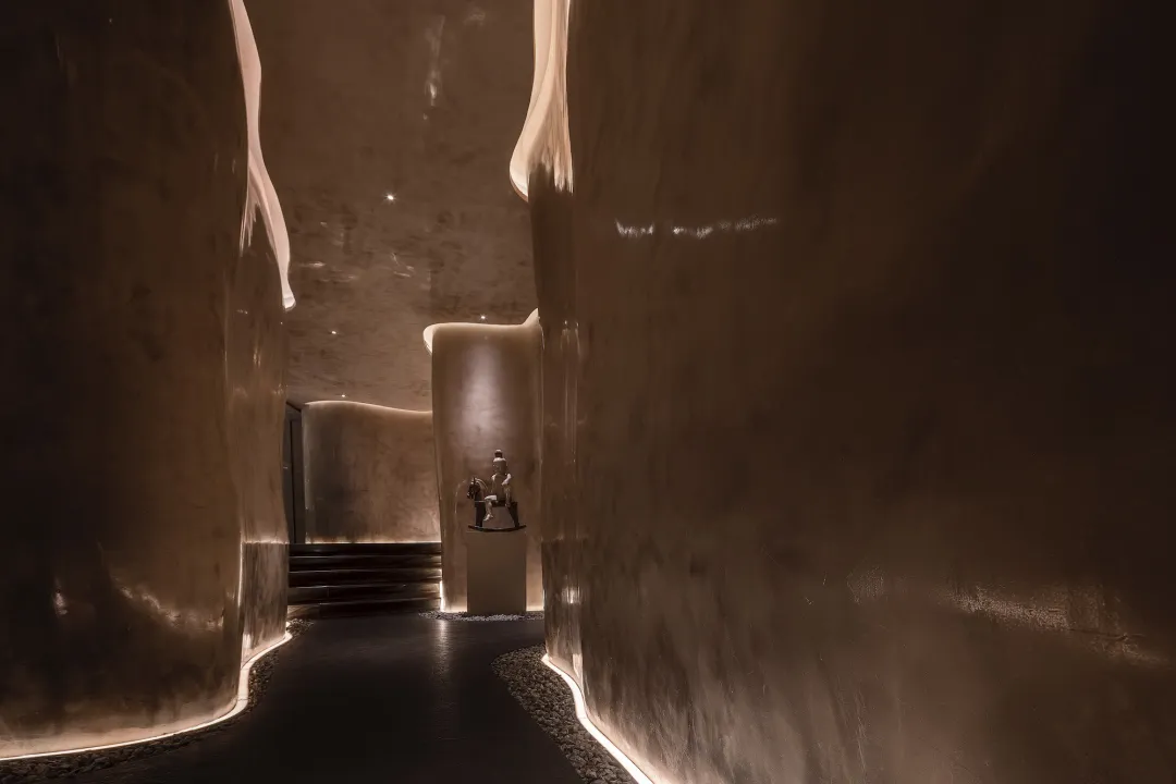 A modern interior space featuring curved concrete walls