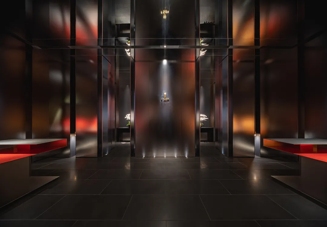 Modern lobby featuring metallic dark interior design with sleek and contemporary elements.