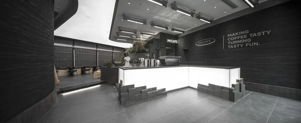Modern minimalist coffee shop bar with exposed concrete and stone elements