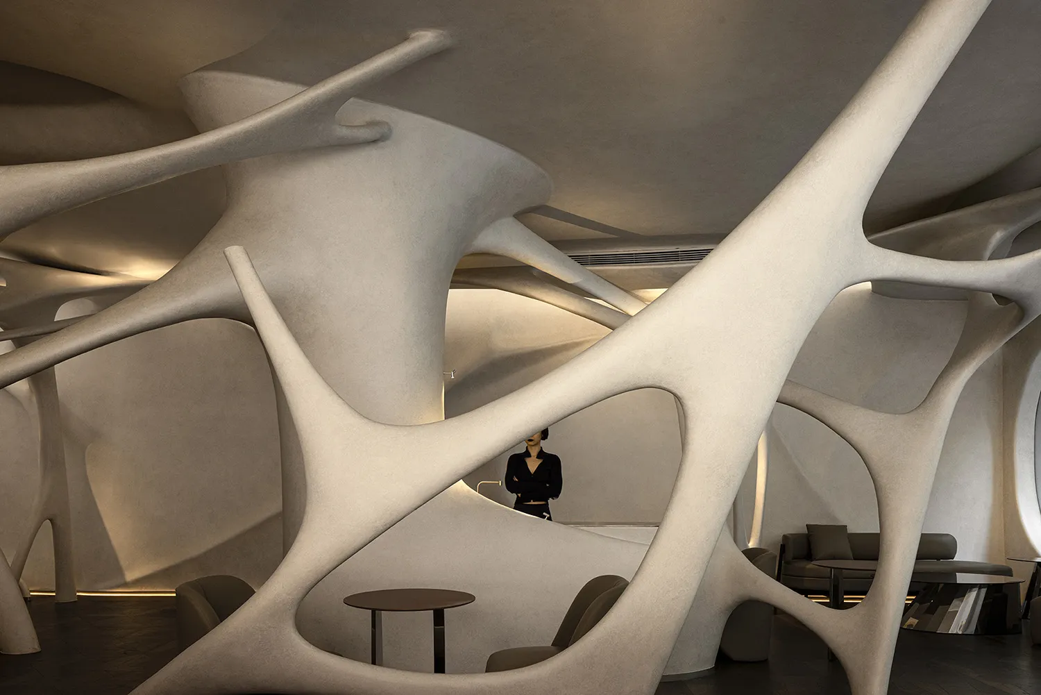 A modern interior space featuring concrete wave-like structures