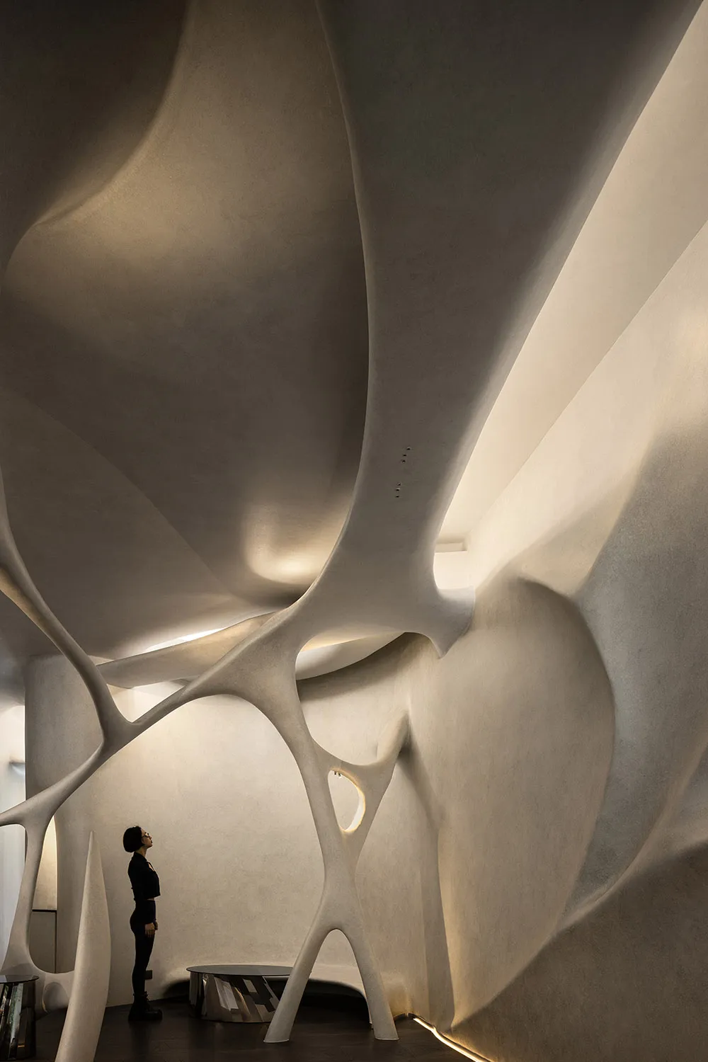 A modern architectural space featuring dramatic concrete structures and curved walls.