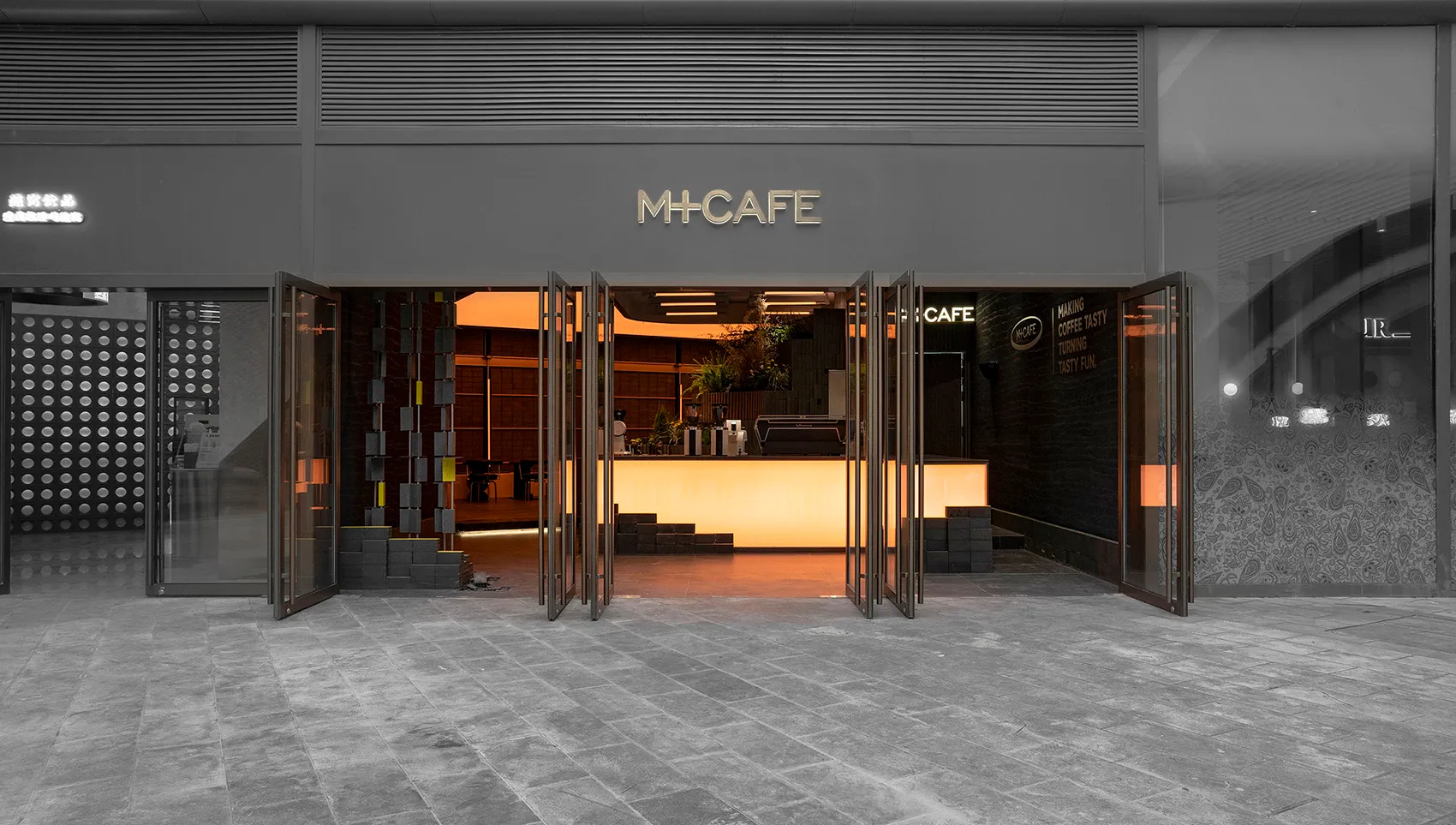 Modern interior of a cafe with glass, metal, and stone materials
