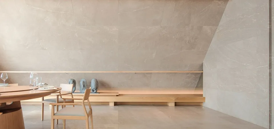 A minimalist interior space featuring marble and wood materials.