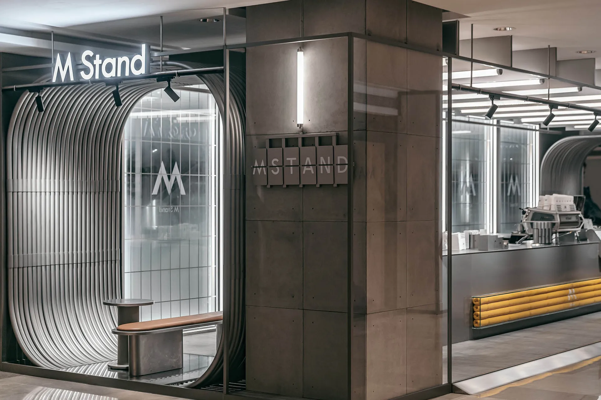A modern industrial storefront with metal and glass features.