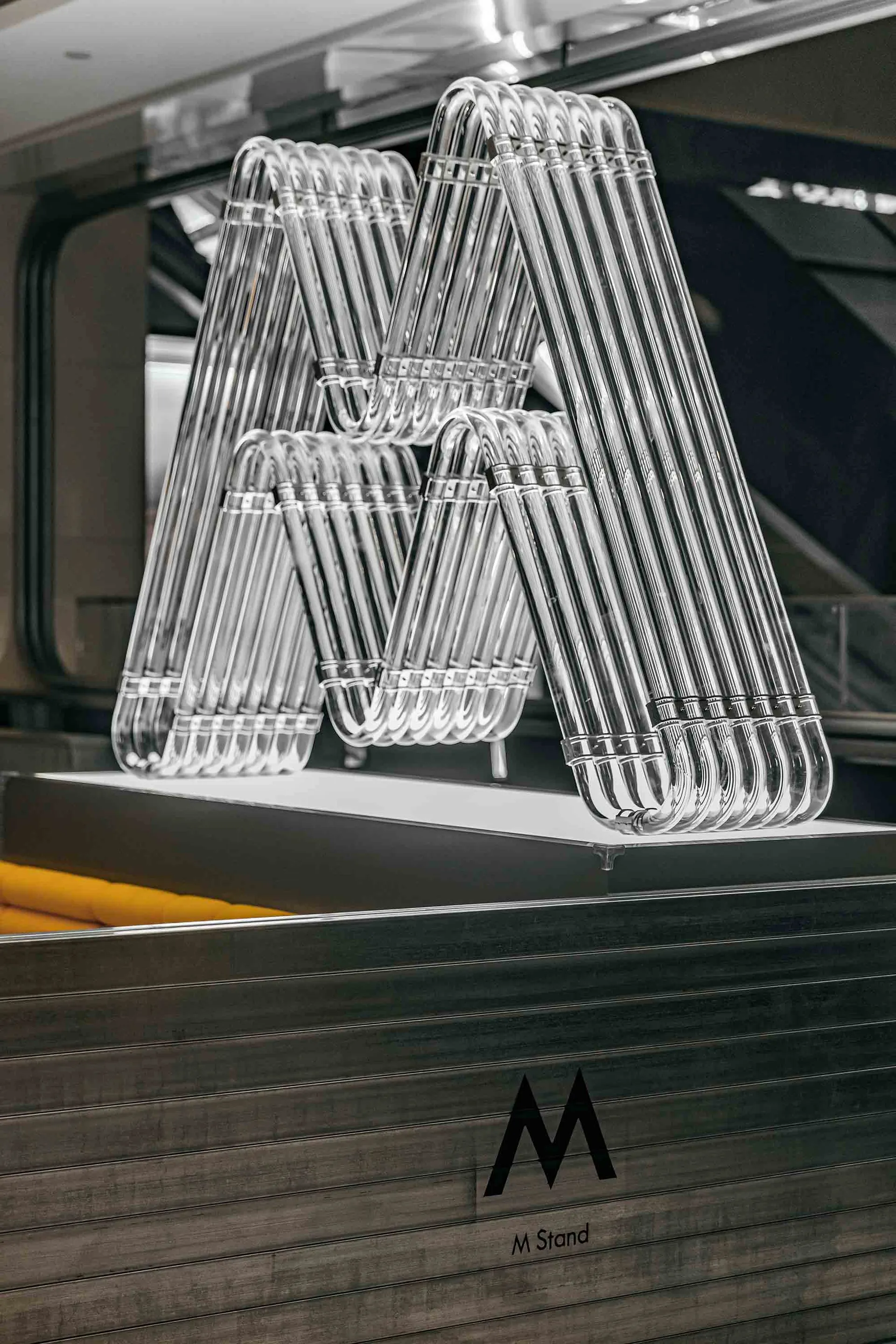 Minimalist metal coat hangers arranged in a triangular pattern for display purposes.