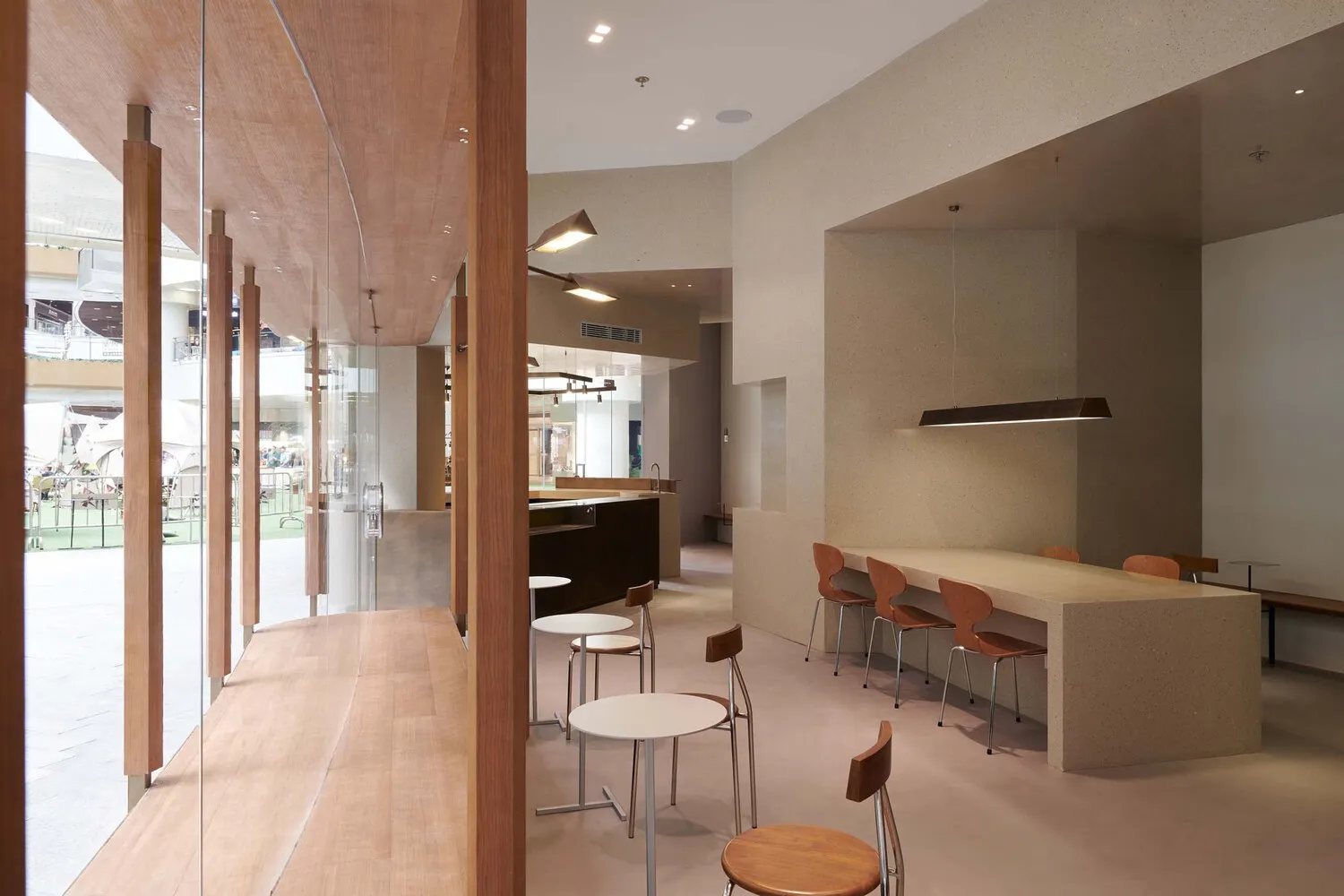 Modern restaurant interior with concrete and wooden elements.