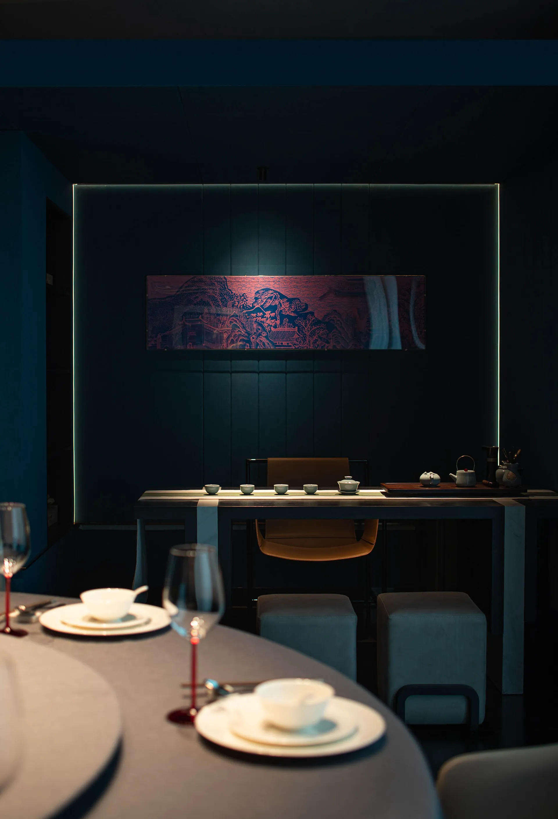 Modern restaurant interior with minimalist design, wooden furniture, and stone accents.