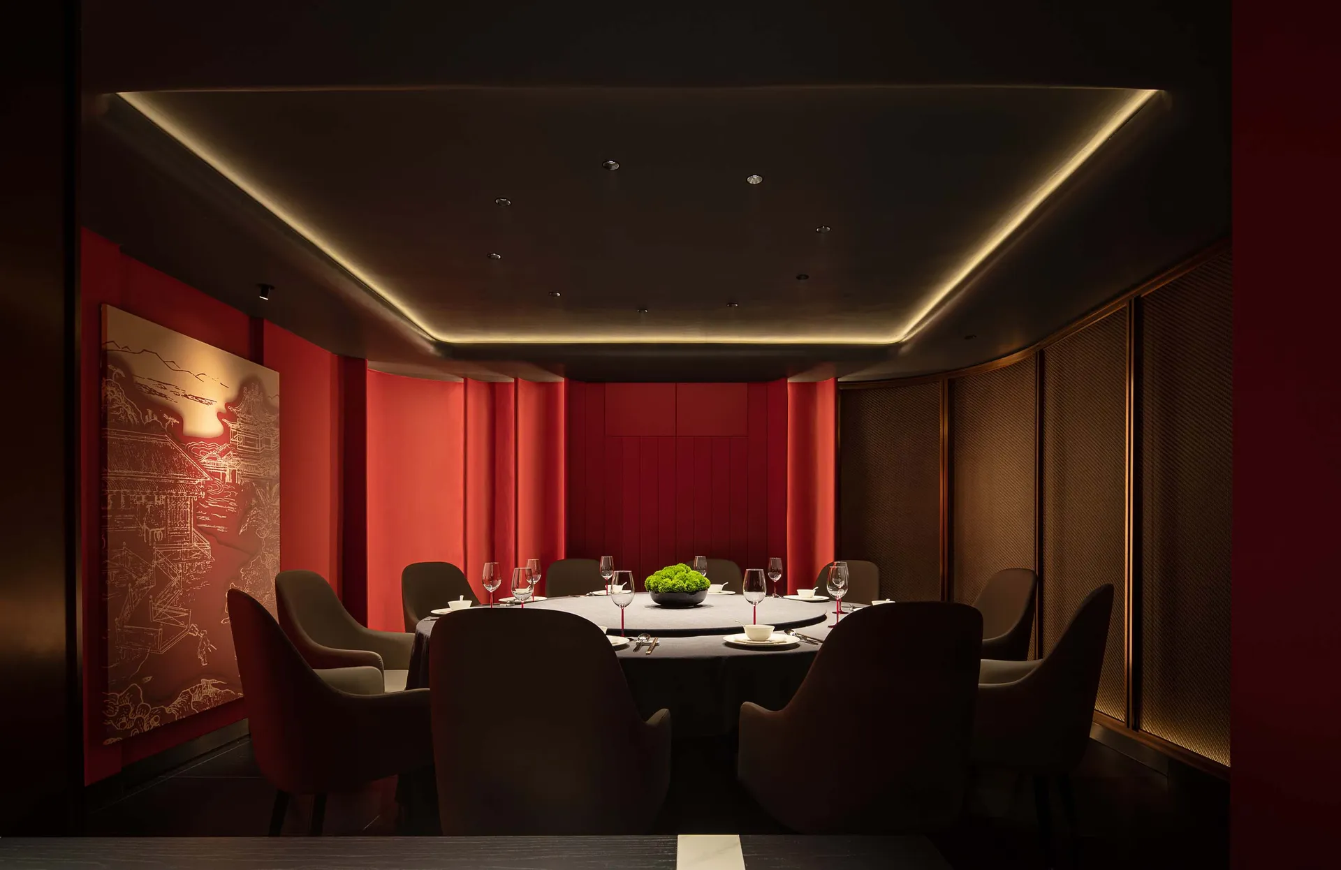 A luxurious restaurant interior with red accent walls and soft furniture.