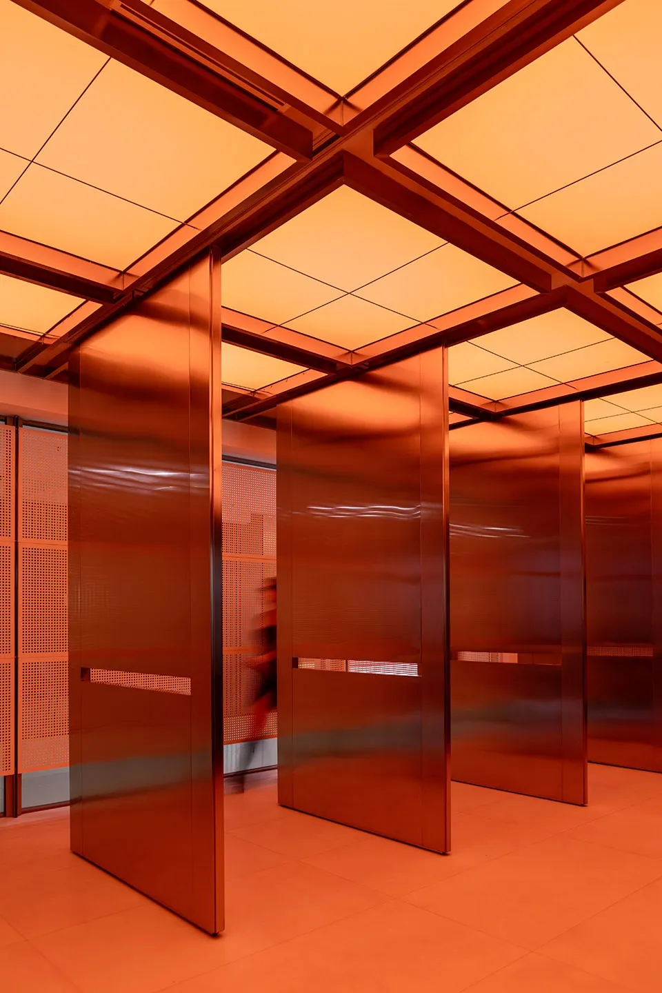 Modern interior with metallic walls and glass panels