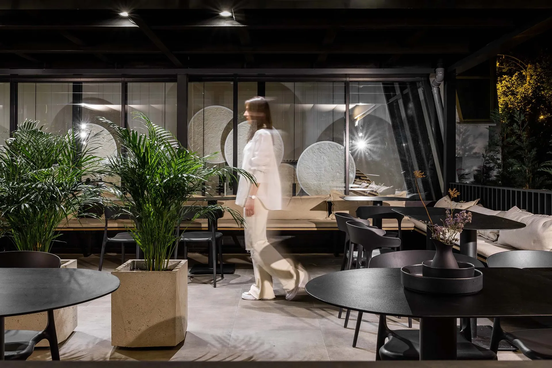 A modern cafe with concrete and glass materials.