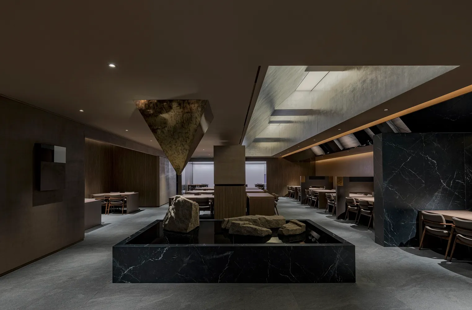 A contemporary restaurant interior featuring luxurious marble materials and sophisticated design elements.