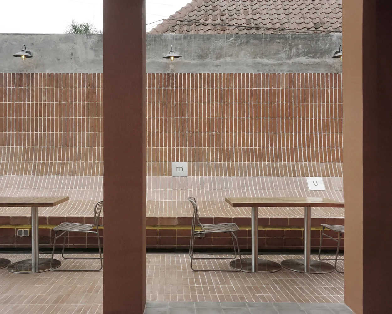 Outdoor seating area with brick walls and tables