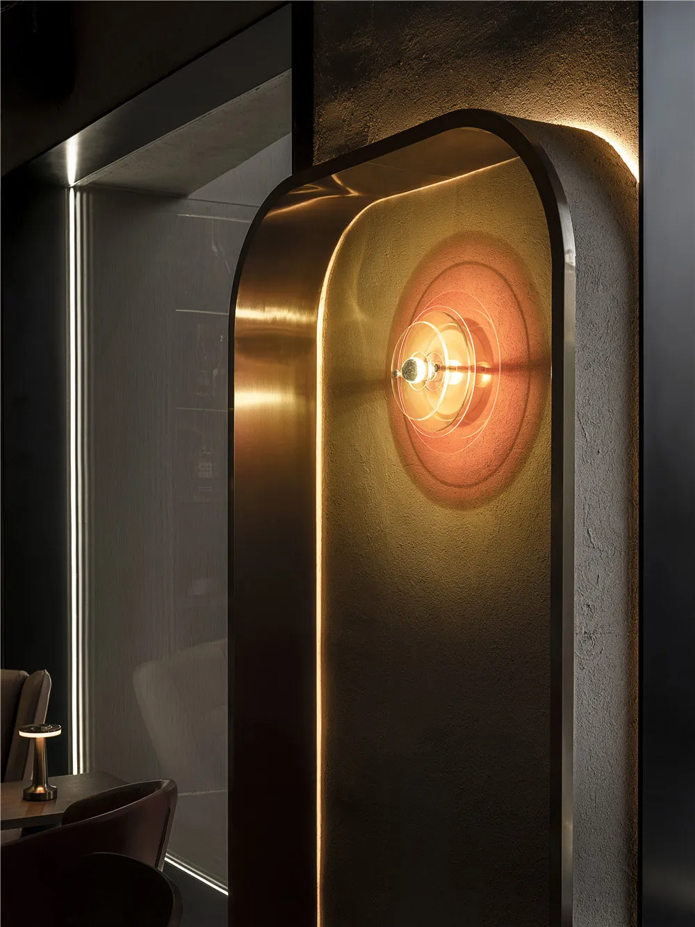A modern office space features brass, glass, and concrete materials.