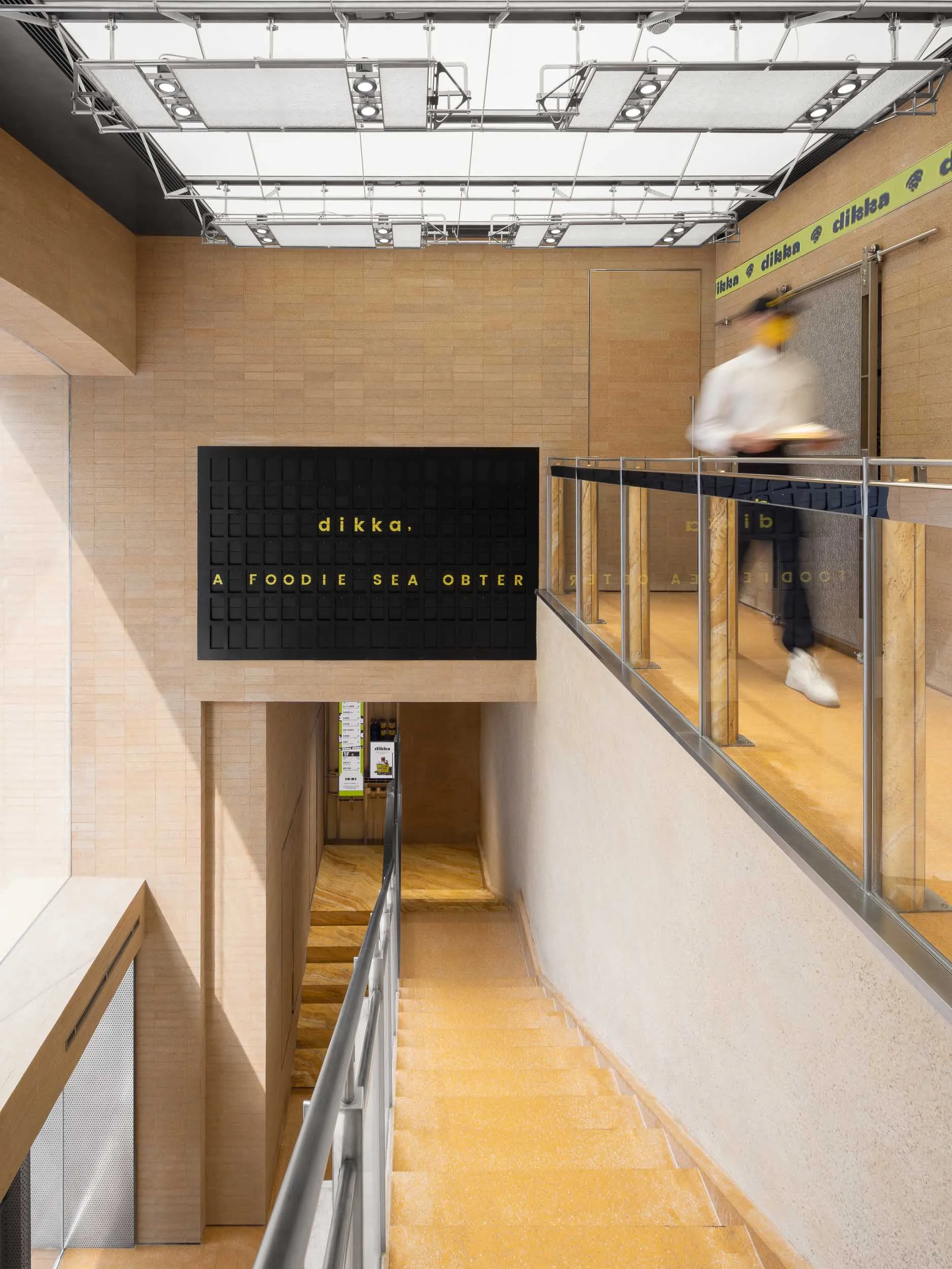 Modern food hall interior with concrete and tile materials, minimalist design.