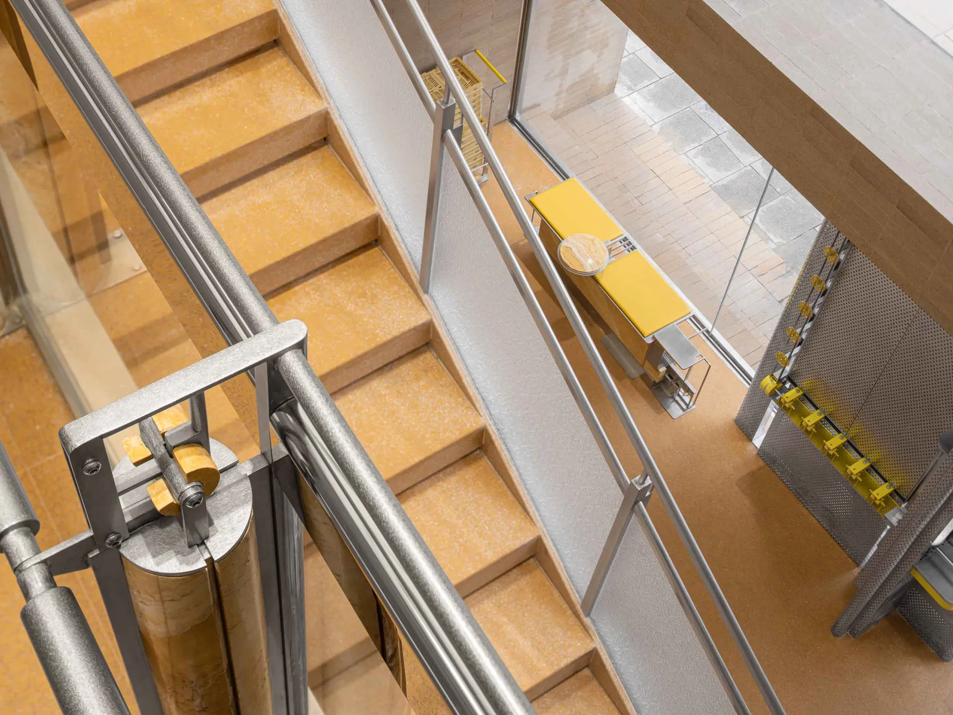Modern staircase with metal railings and cork flooring