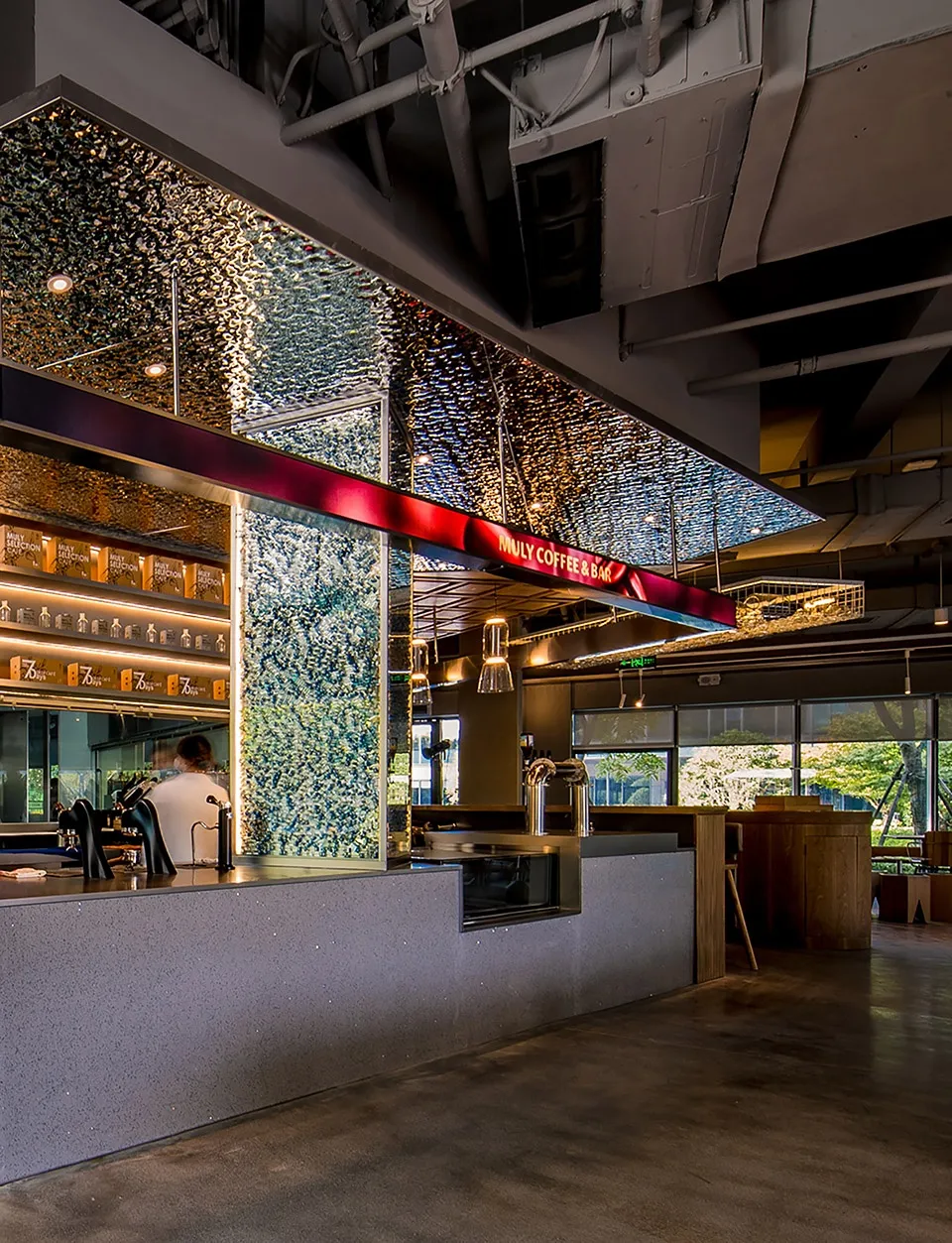 Interior of a modern cafe featuring a glass ceiling with illuminated elements.