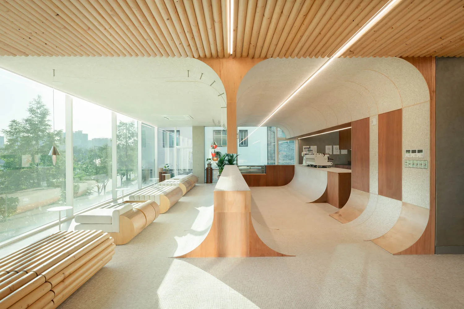 A minimalist cafe with wooden and concrete design elements.