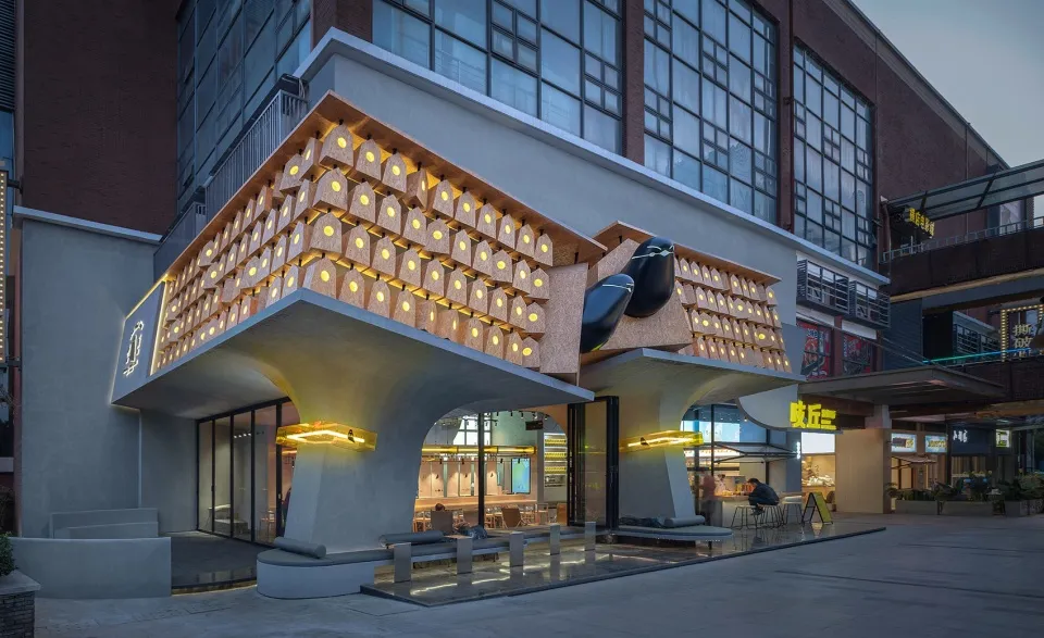 A modern retail storefront featuring a unique wooden architectural design with illuminated elements.