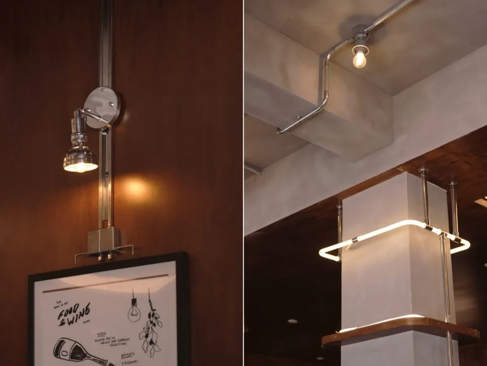 Industrial-style lighting fixtures mounted on a concrete ceiling, showcasing minimalist design and modern aesthetic.