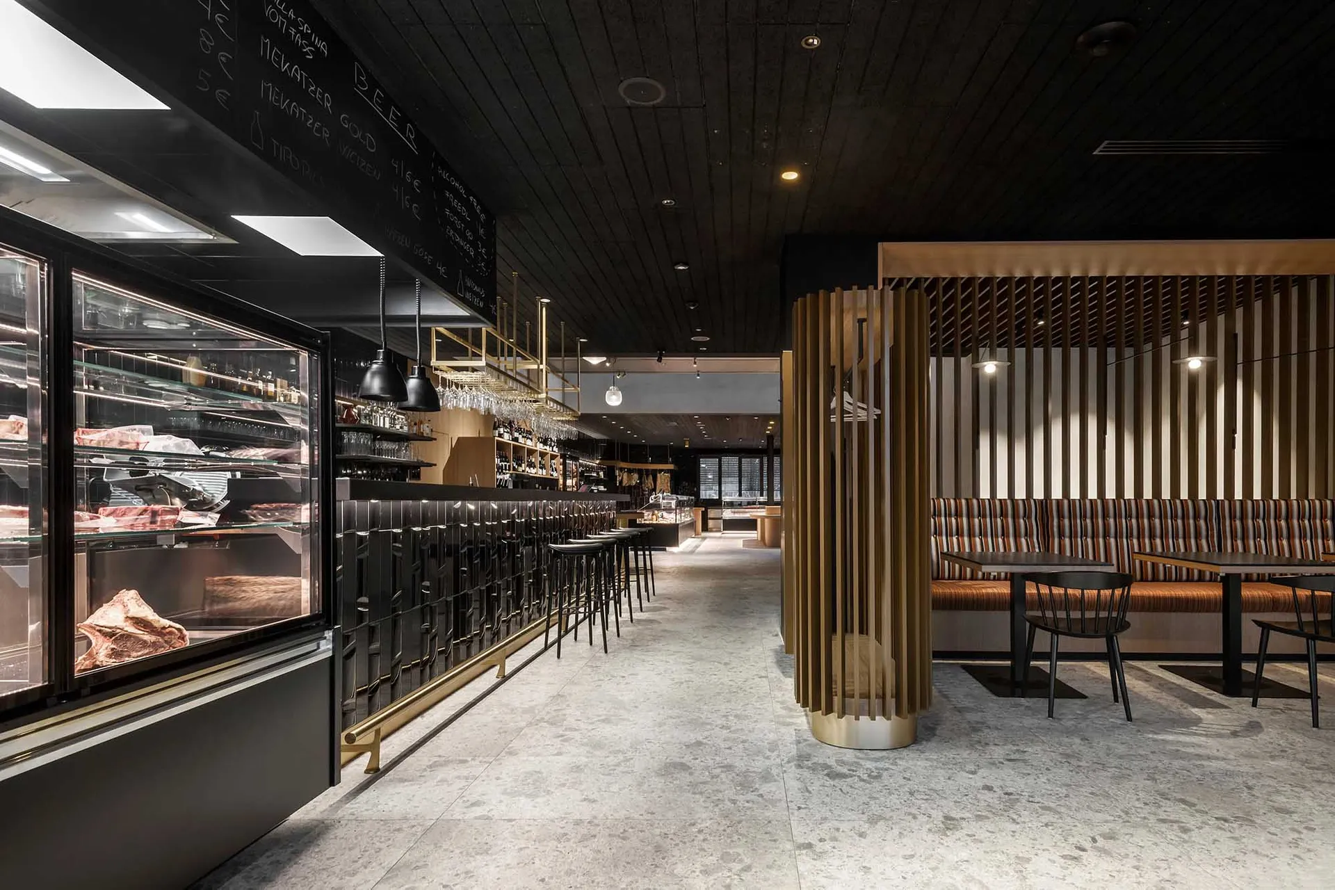 Industrial-style restaurant interior with black metal and wood finishes.