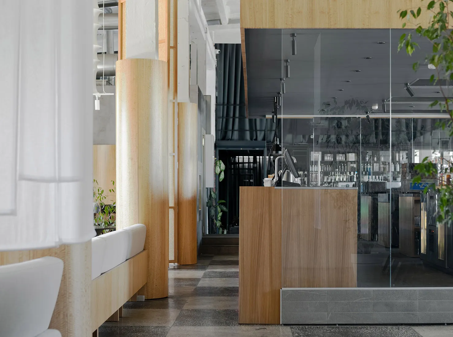 Modern cafe interior with wooden pillars and glass walls featuring contemporary design elements.