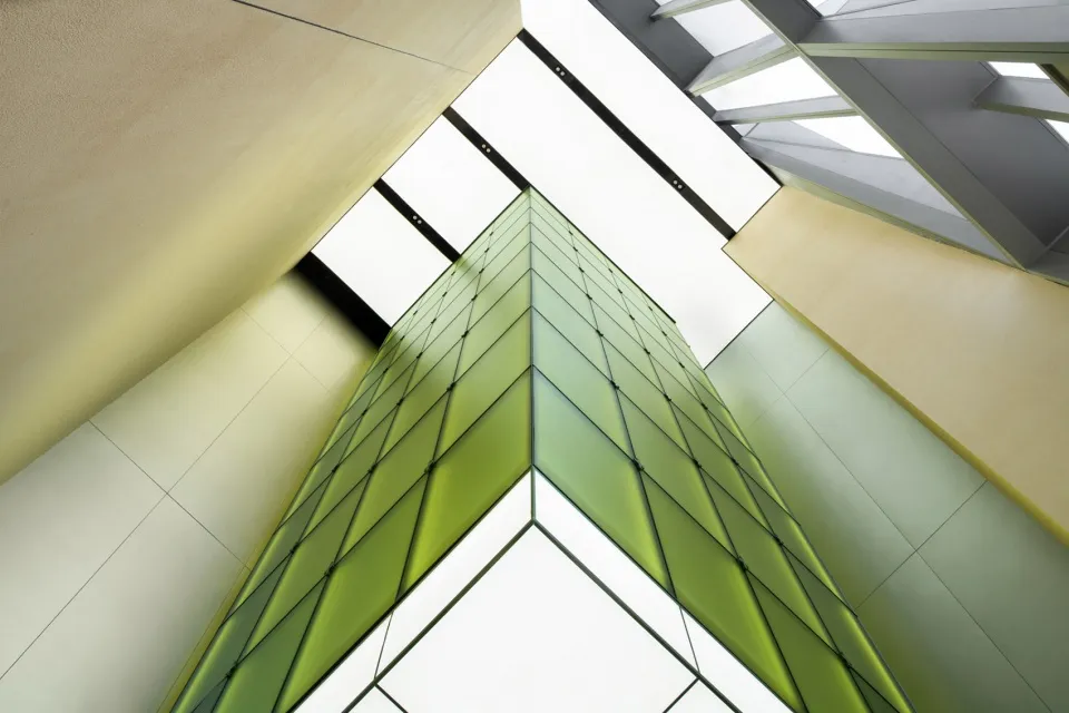 A modern architectural design featuring glass and metal materials.