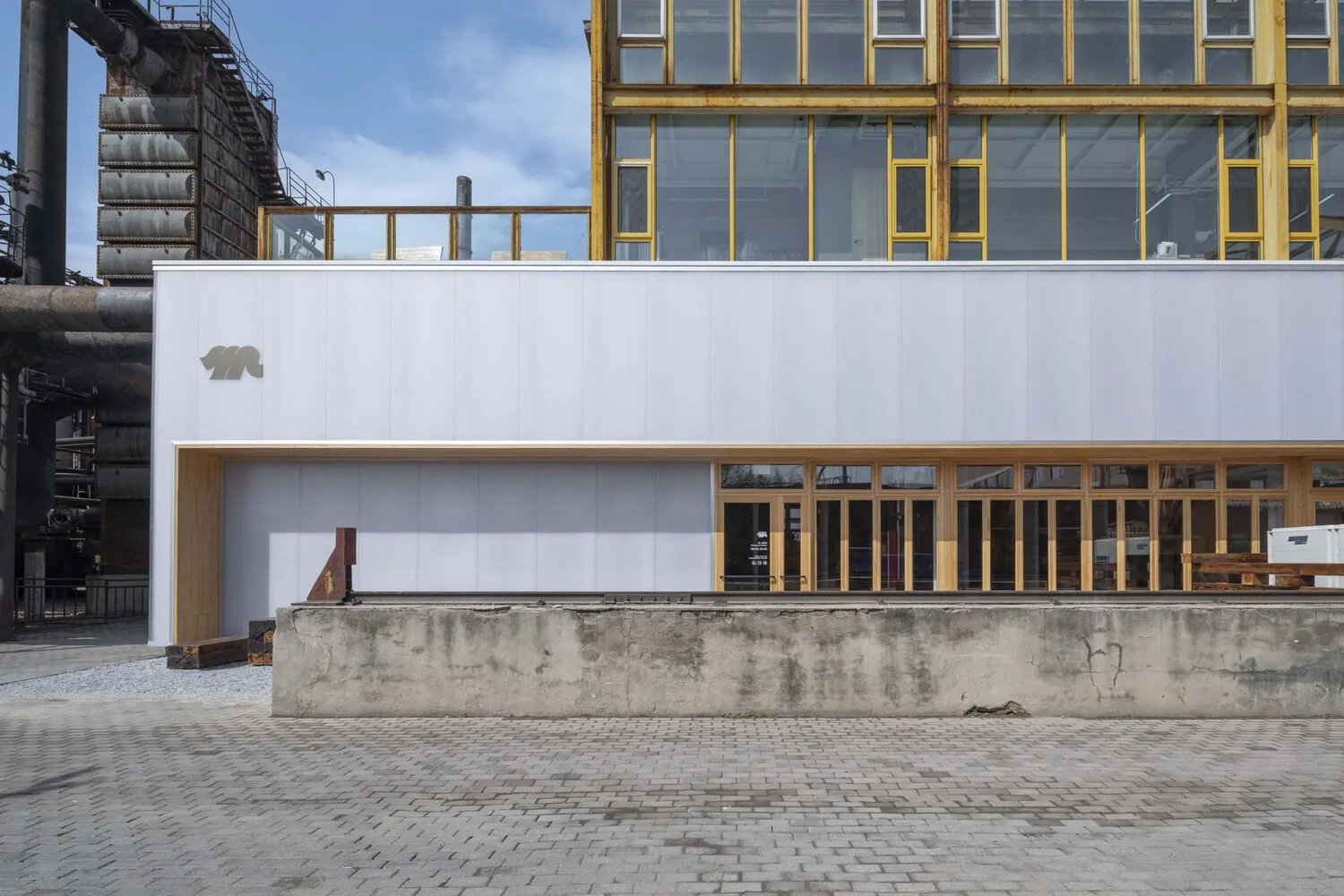 Industrial building featuring metal, concrete, and glass materials.