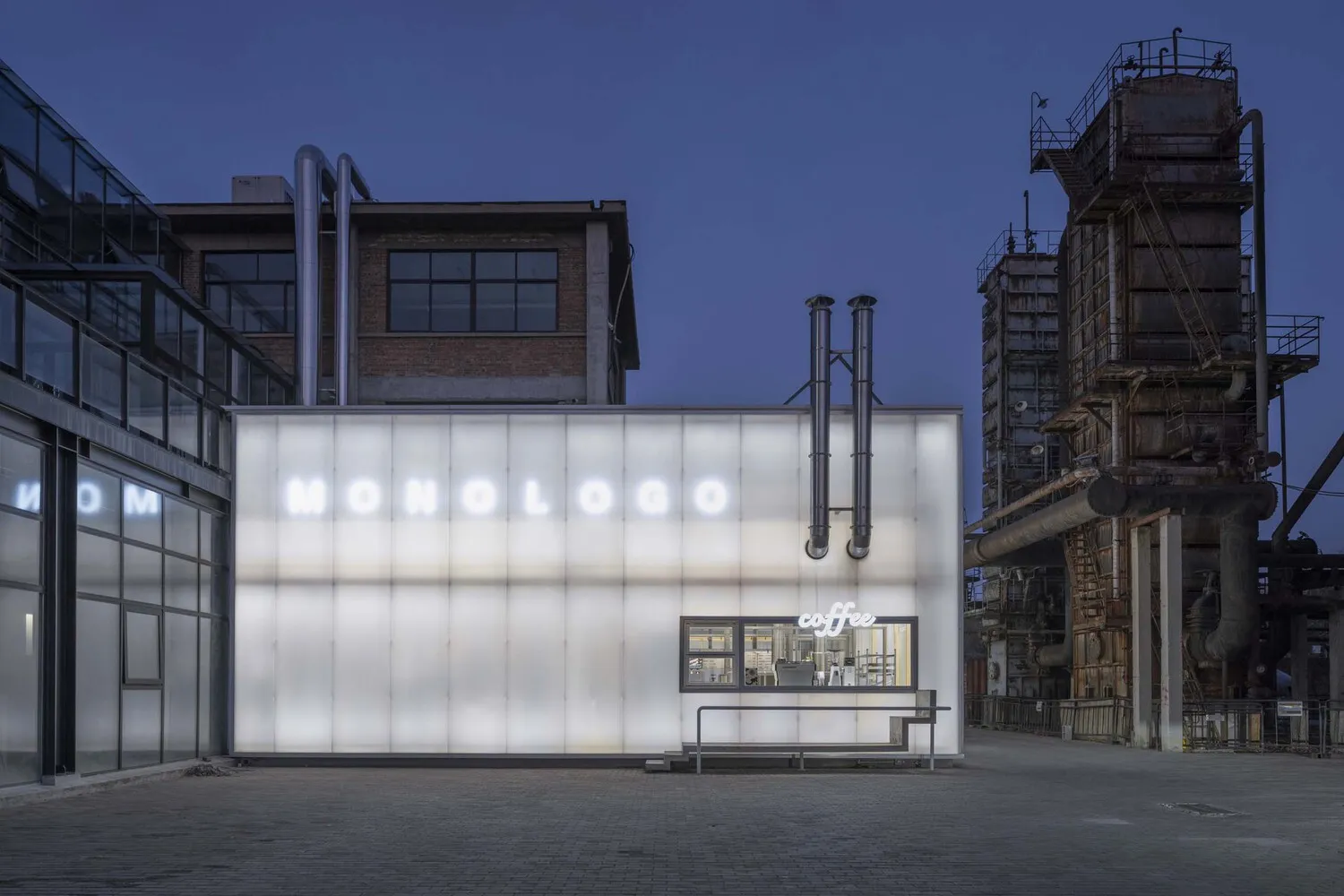 A minimalist coffee shop exterior with glass paneling.