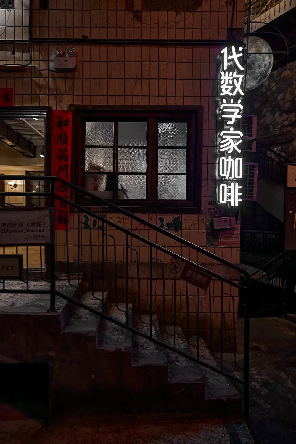 Concrete staircase illuminated by neon signs in a nighttime urban setting