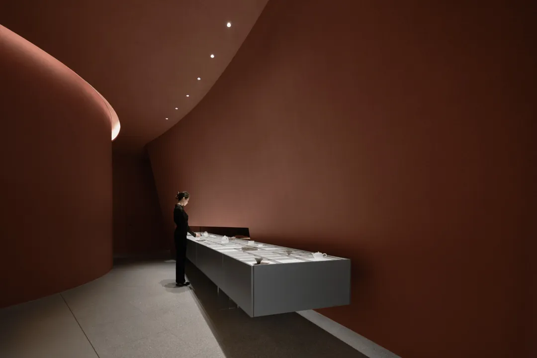 A minimalist bar with a dark marble countertop, featuring sleek design elements and a contemporary aesthetic.