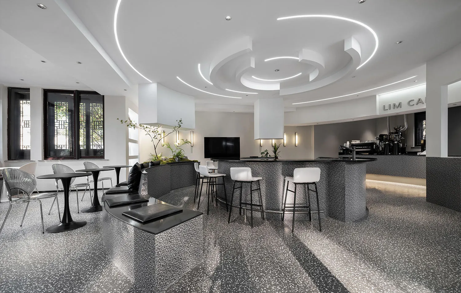 Modern coffee shop interior featuring minimalist design with terrazzo flooring.