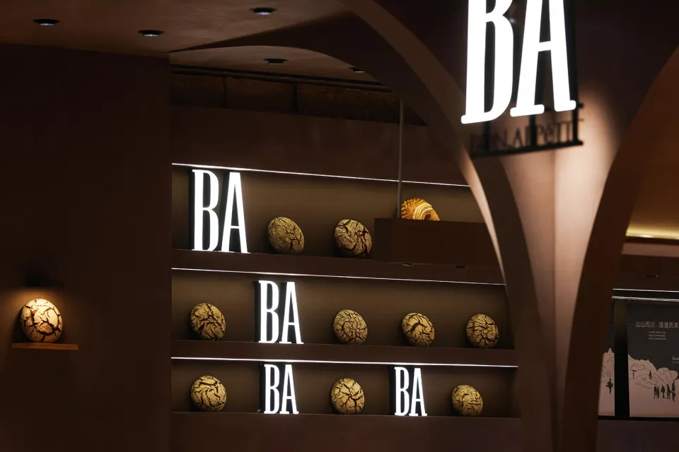 A display of food items with neon lights in a concrete setting.