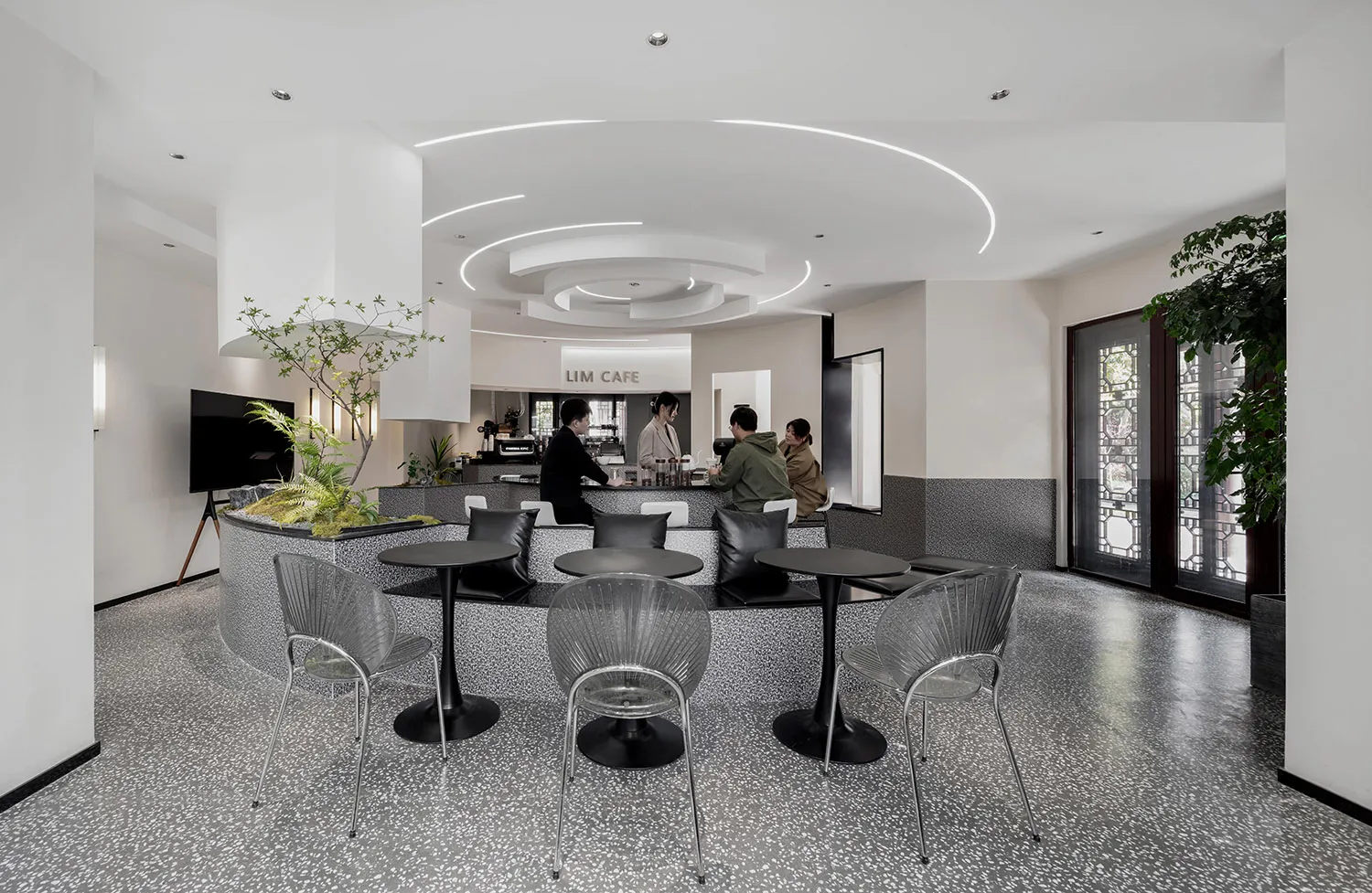 Modern cafe with black and white interior design, featuring sleek furniture and contemporary decor.