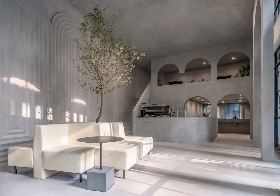 Modern coffee shop interior designed with concrete materials