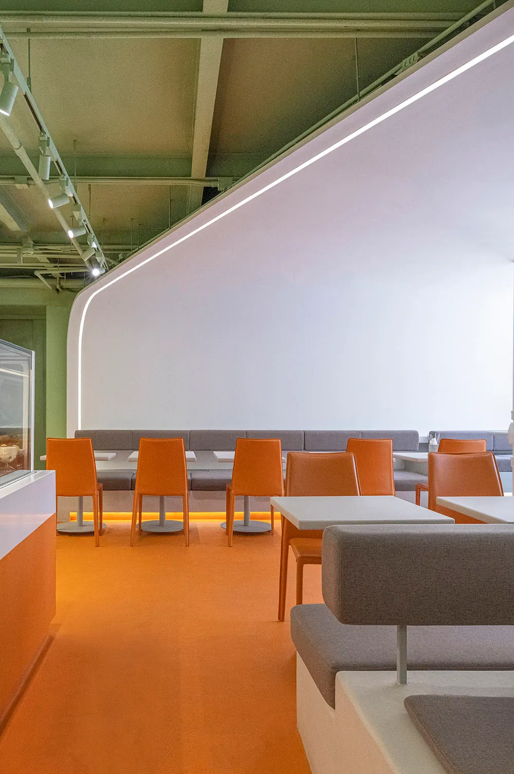 Modern restaurant interior with concrete floating tables and seating