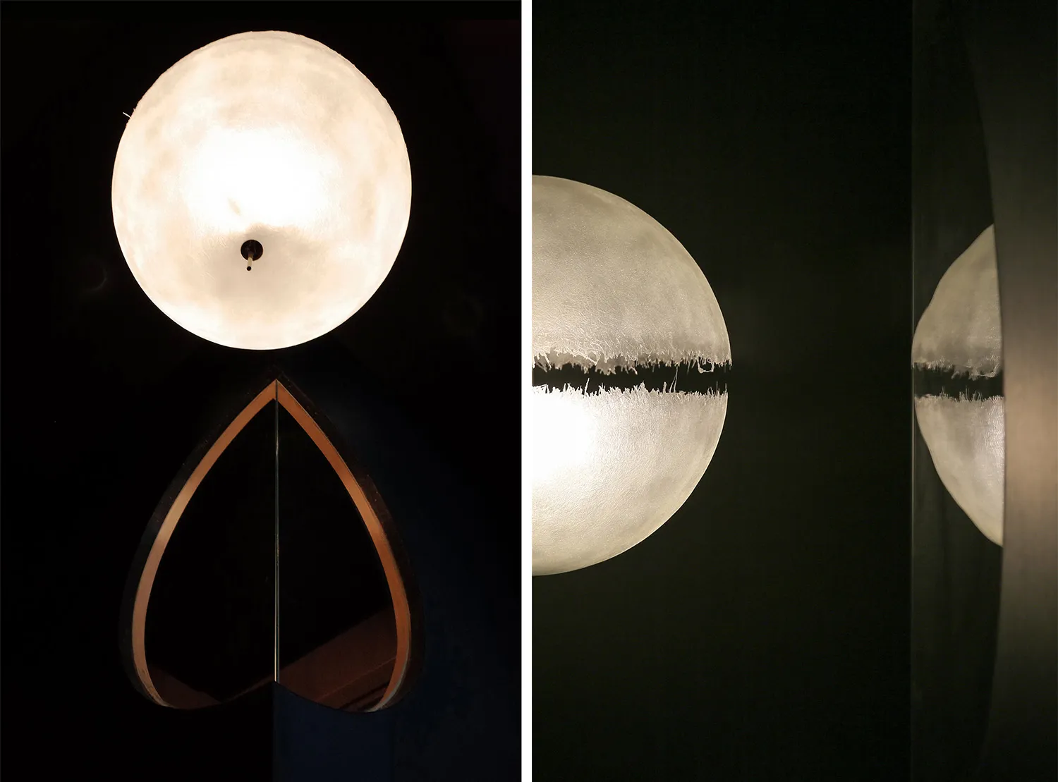 A metallic sphere lamp casting a reflection on a dark surface.