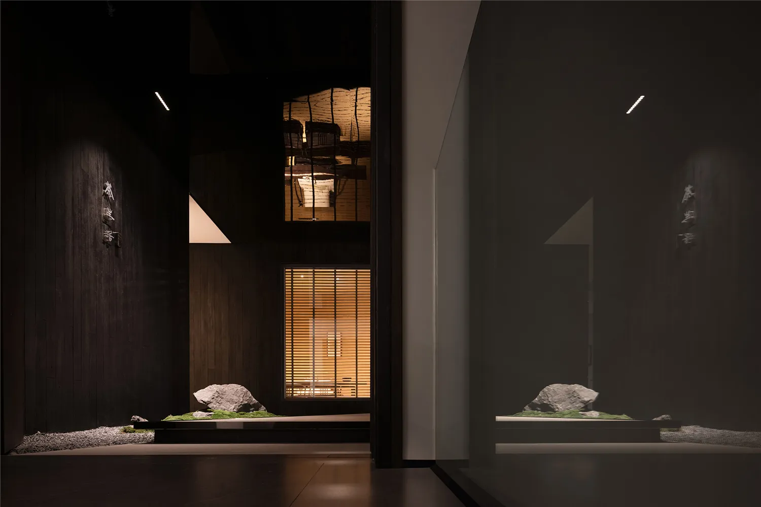 Minimalist interior with dark wood walls and a glass window.