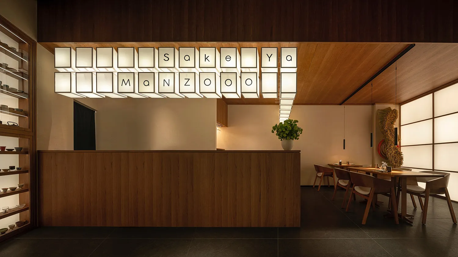 A modern restaurant interior with wooden materials and a sleek, minimalist design.