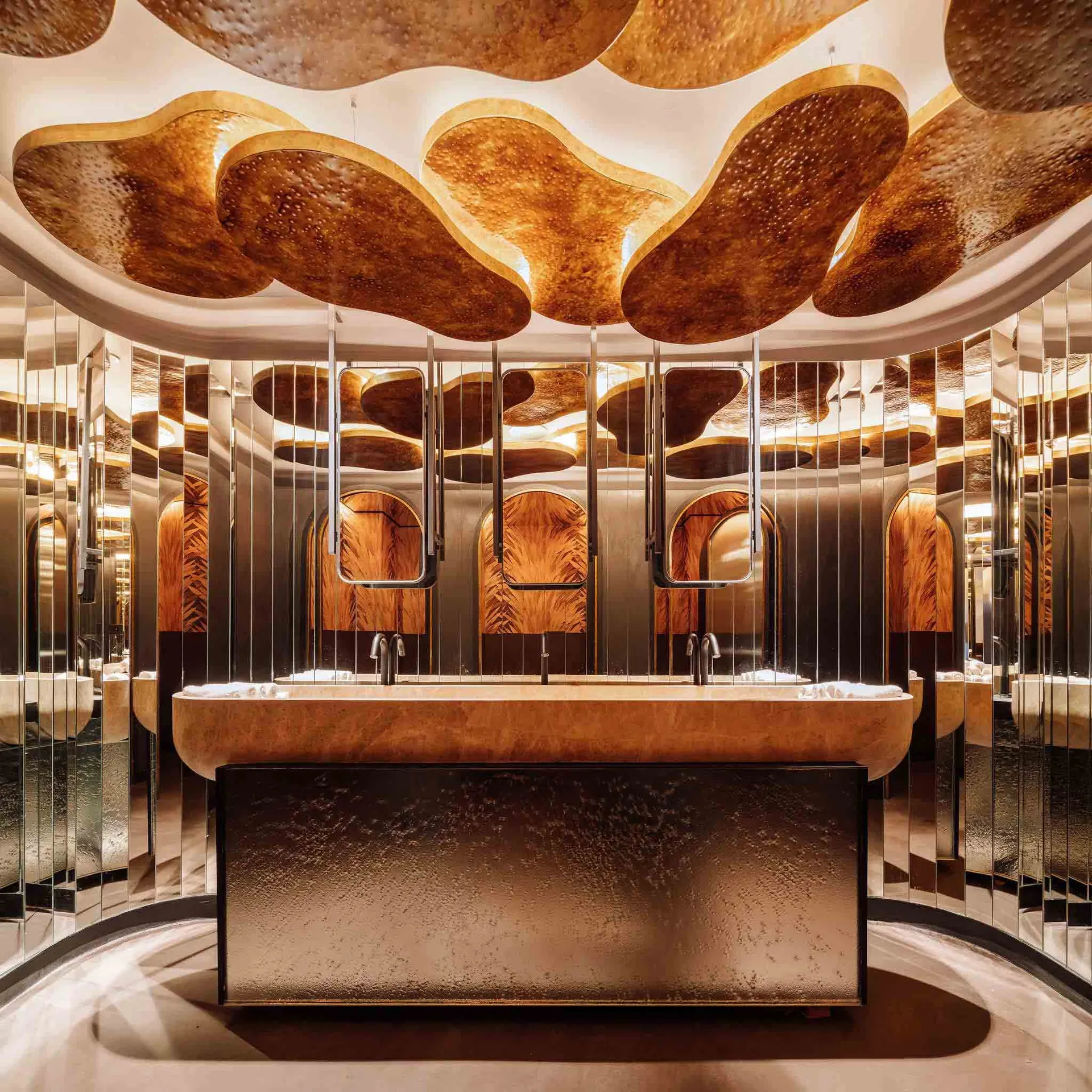 Modern bathroom interior with glass walls, a large bathtub, and a ceiling with organic, cloud-like shapes.