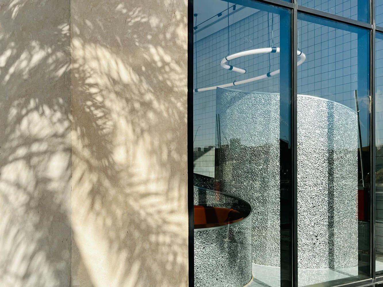 The image features a modern architectural design with concrete materials.