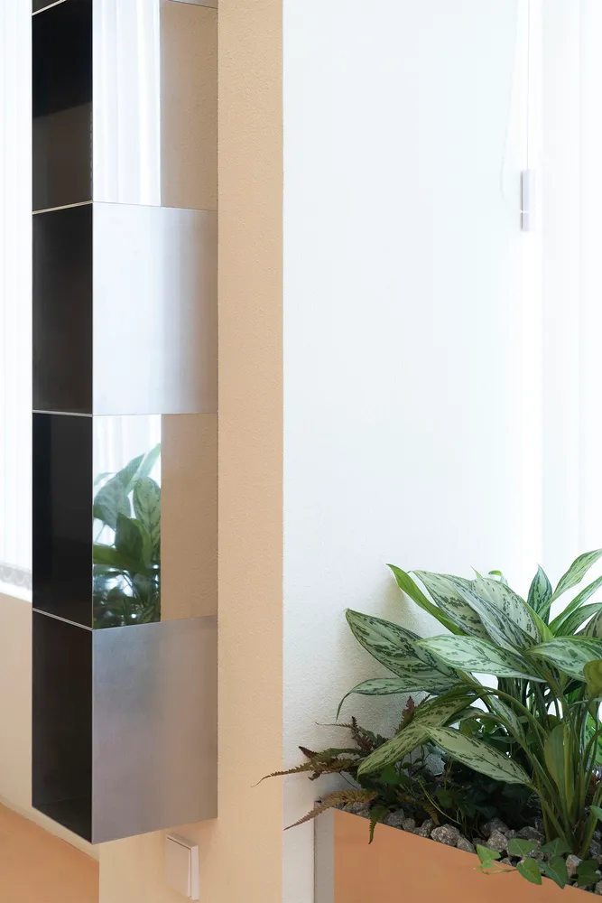 Modern art modernism metal planter featuring a sleek, minimalist design with green foliage.