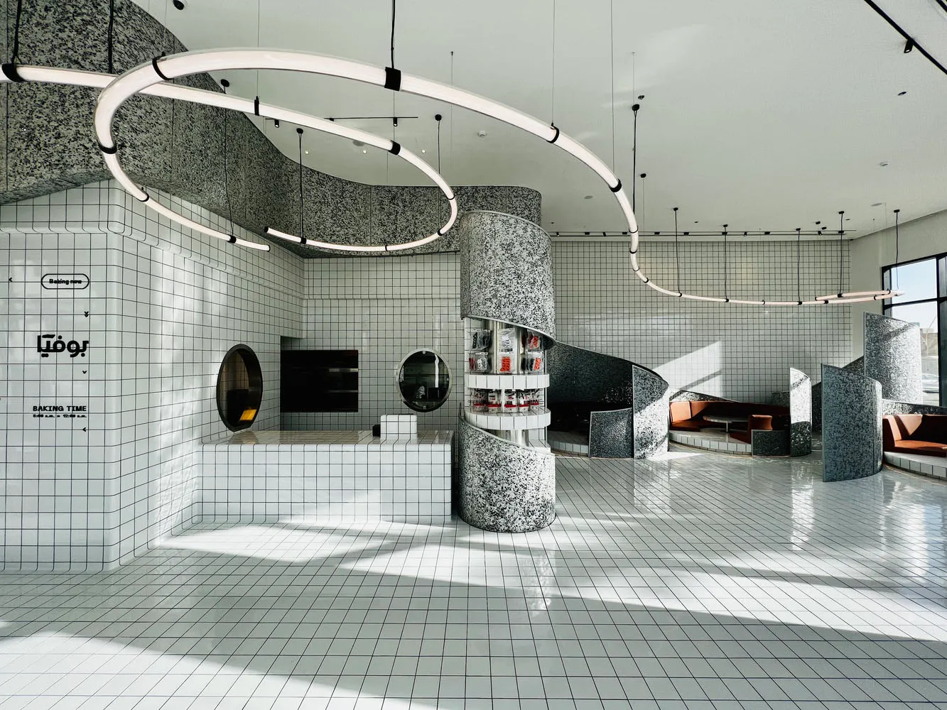 Modern coffee shop interior with tiled flooring, concrete and steel elements