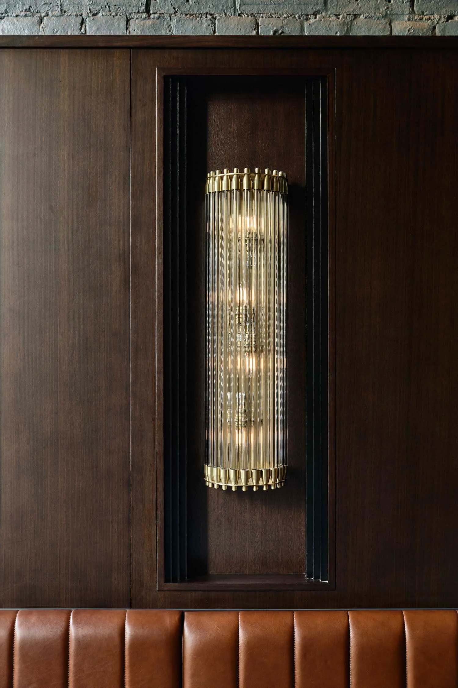 Modern wall lighting fixture with metal and glass elements.