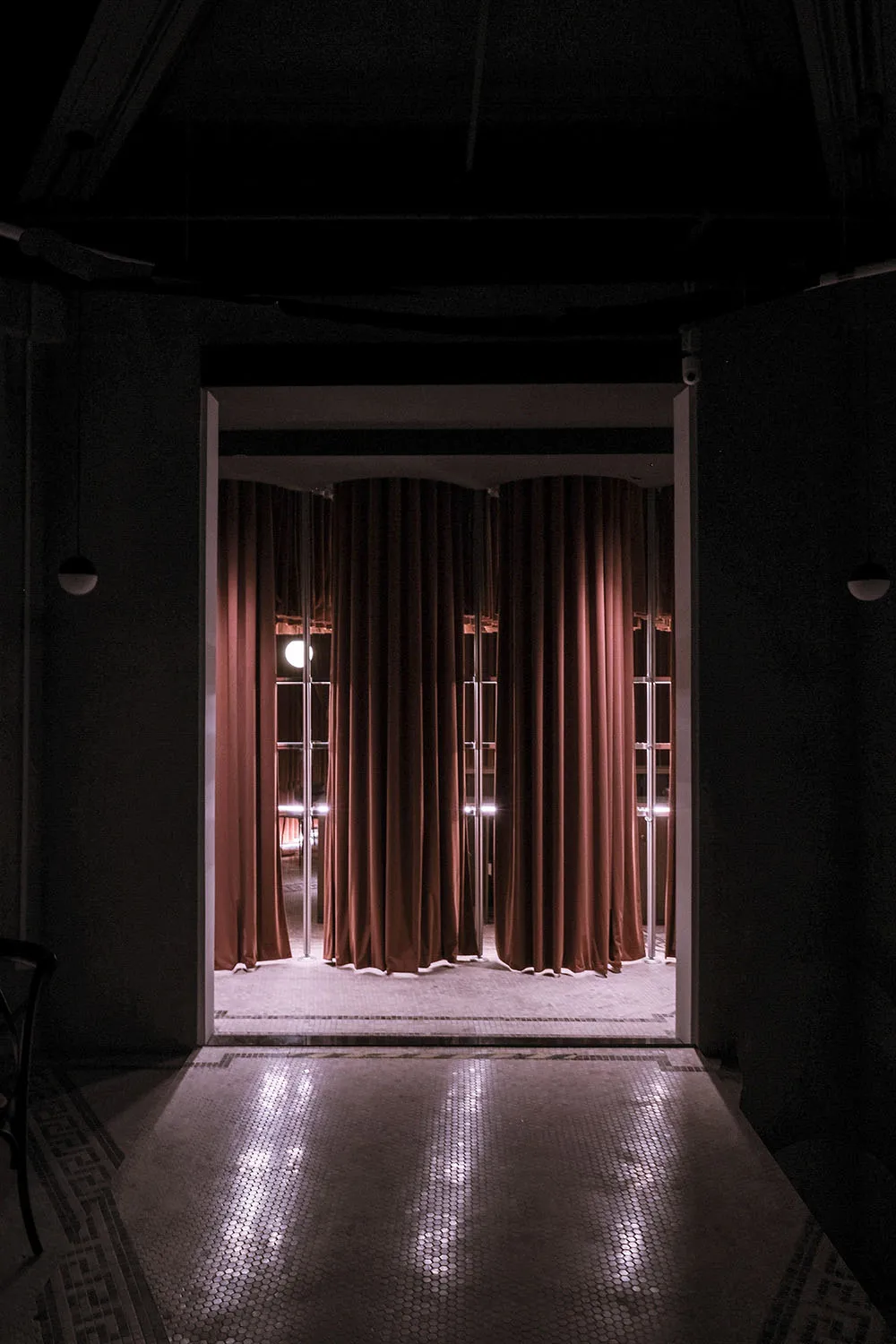 Minimalist room with red curtains on a tiled floor