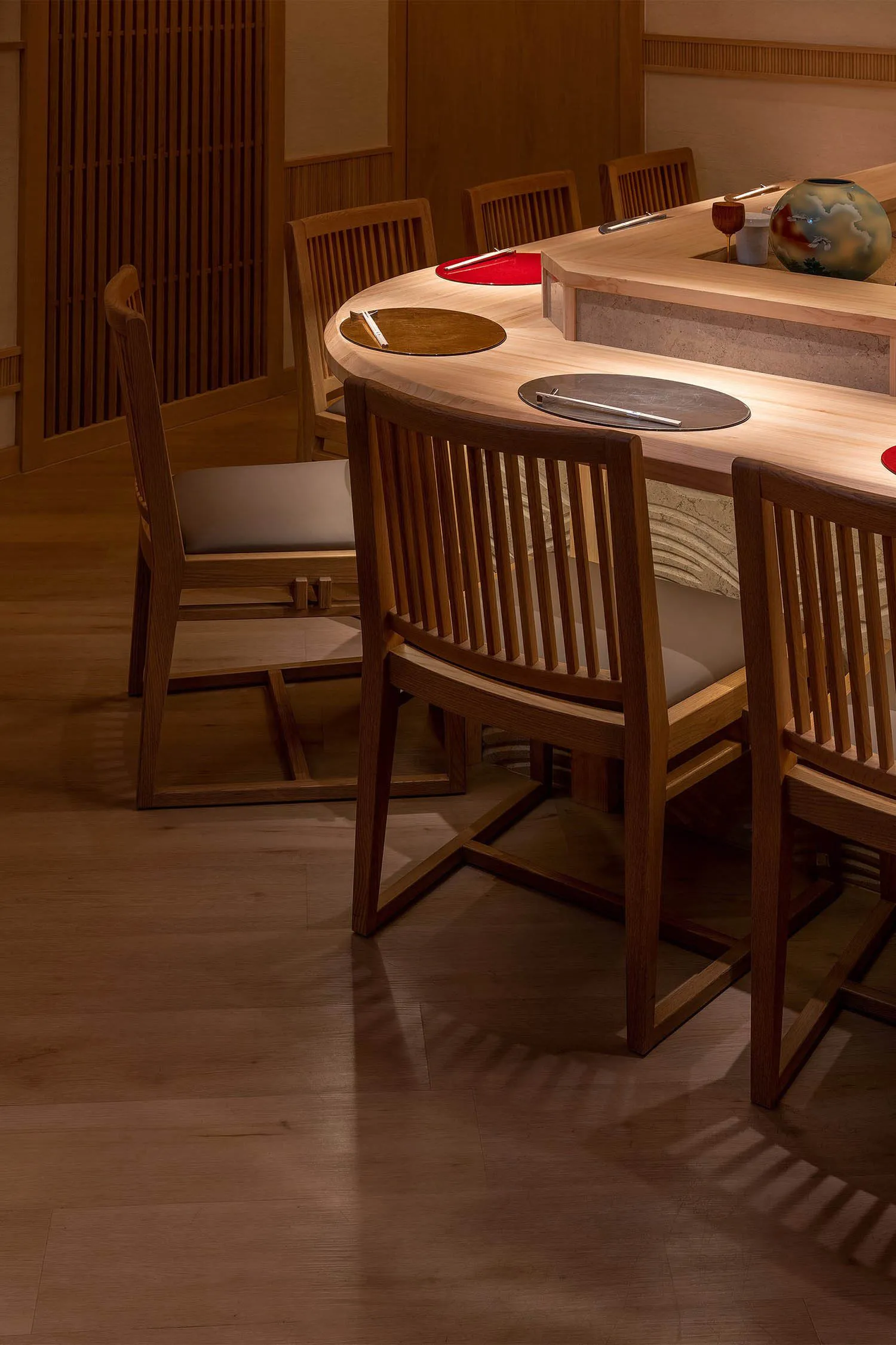 A modern restaurant setting with wooden tables and chairs