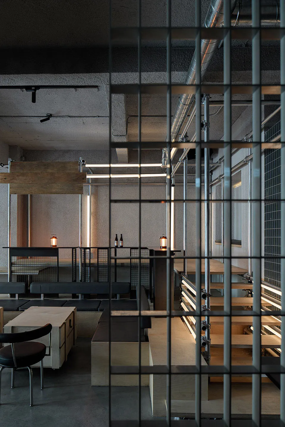 An industrial-style restaurant interior featuring concrete and steel materials.
