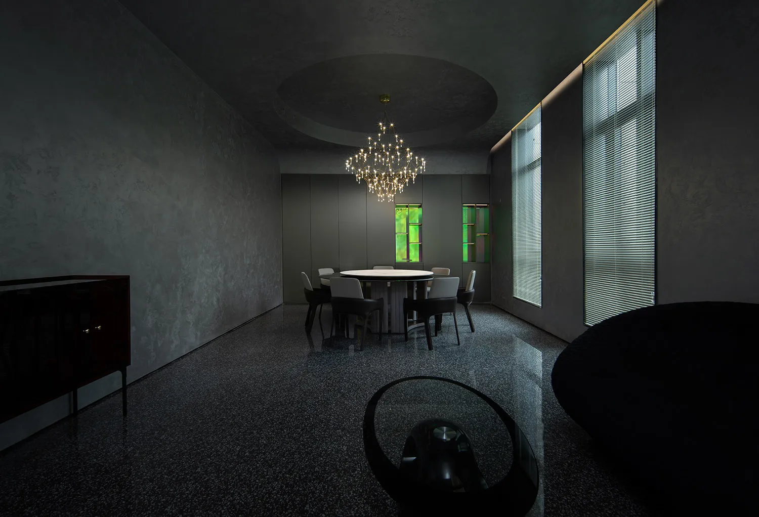 Modern dining room featuring glass elements and contemporary design.