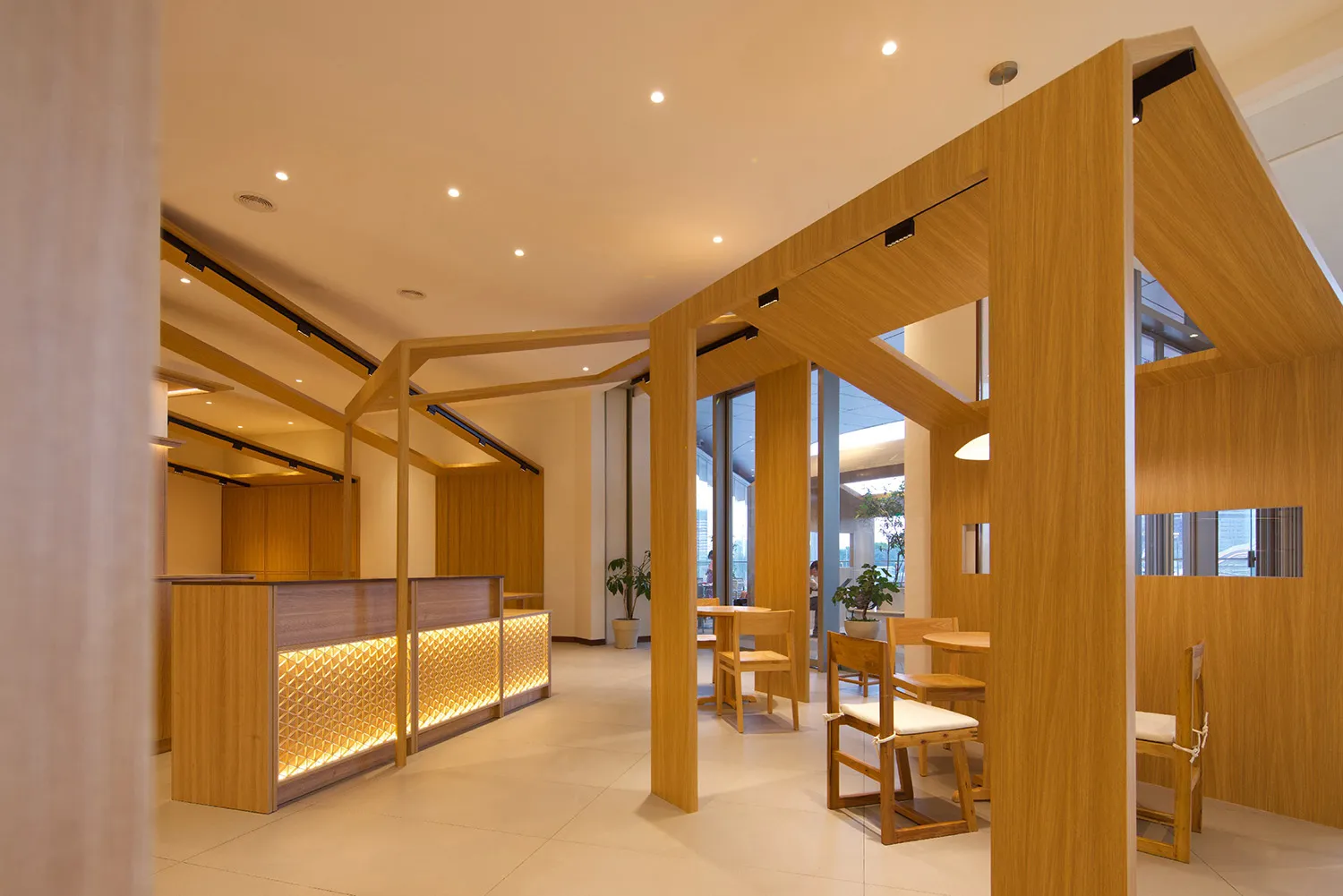 Modern office space featuring wooden panels and furniture, with a contemporary design.